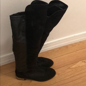 Knee high black leather and suede boots